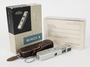 MINOX: Chrome-body Minox B subminiature camera [#942 506], circa 1964, with Complan 15mm f3.5 lens, in original maker's box with leather case, wrist chain, and printed materials. Scale in meters.