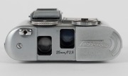 CONCAVA: Chrome-body Tessina L subminiature camera [#166859], circa 1985, with Tessinon 25mm f2.8 lens. Presented in maker's box with dusting brush accessory. - 4