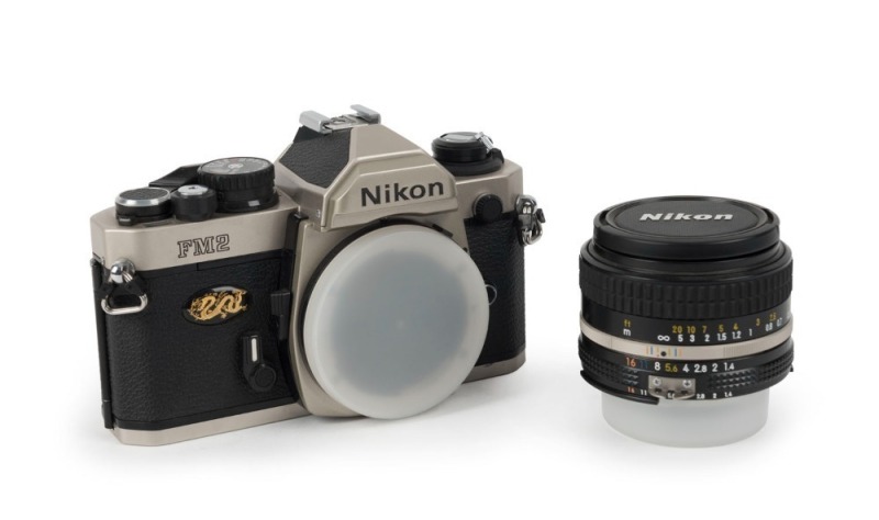 NIPPON KOGAKU: Nikon FM2 Millennium Edition Kit [1292/2000] with champagne-gold FM2 SLR camera and Nikkor 50mm f1.4 lens, both bearing matching serial numbers. Presented in a gold, velvet-lined maker's box together with front and rear lens caps, retail bo