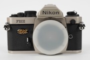 NIPPON KOGAKU: Nikon FM2 Millennium Edition Kit [1292/2000] with champagne-gold FM2 SLR camera and Nikkor 50mm f1.4 lens, both bearing matching serial numbers. Presented in a gold, velvet-lined maker's box together with front and rear lens caps, retail bo - 2