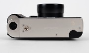 KONICA: 1994 anniversary-edition&nbsp;'Century of Camera Excellence' Hexar Rhodium [#0100003] viewfinder camera, with Hexar&nbsp;35mm f2 lens. Presented in wooden, felt-lined&nbsp;maker's box, together with&nbsp;metal&nbsp;lens cap,&nbsp;HX-14 Auto flash unit [#2039631], leather strap - 6