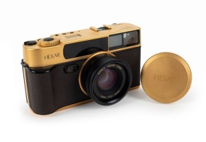 KONICA: 1993 120th-anniversary edition Hexar Gold [#EG0000003] viewfinder camera, with Hexar 35mm f2 lens. This camera features a burnished gold finish with a 24-carat gold serial number plate affixed to the side, indicating that this particular example w