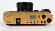 KONICA: 1993&nbsp;120th-anniversary edition&nbsp;Hexar Gold [#EG0000003] viewfinder camera, with Hexar&nbsp;35mm f2 lens. This camera features a burnished gold finish with a 24-carat gold serial number plate affixed to the side,&nbsp;indicating that this particular example w - 7