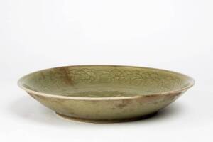 A large Chinese celadon glazed dish decorated with peony, 30.5cm diameter