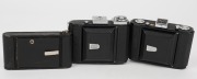 ZEISS IKON: Three vertical folding cameras - one circa 1949 Ikonta 521 [#N 52211 *] with Novar 75mm f6.3 lens, one circa 1929 Ikonette 504/12 with Frontar 80mm f9 lens, and one circa 1937 Nettar 515 [#F 31094] with Novar 75mm f4.5 lens. (3 cameras) - 3