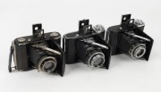 ZEISS IKON: Three vertical folding cameras - one circa 1949 Ikonta 521A [#P 65098 *] with Novar 75mm f4.5 lens, one circa 1929 Ikonta 521A [#F 49599] with Novar 75mm f3.5 lens, and one circa 1936 Ikonta 520 with Tessar 70mm f3.5 lens [#1737109]. (3 camera