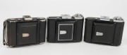 ZEISS IKON: Three vertical folding cameras - one circa 1949 Ikonta 521A [#P 65098 *] with Novar 75mm f4.5 lens, one circa 1929 Ikonta 521A [#F 49599] with Novar 75mm f3.5 lens, and one circa 1936 Ikonta 520 with Tessar 70mm f3.5 lens [#1737109]. (3 camera - 3