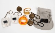 LEITZ: Eight Leica promotional keychains made of various materials, one in its original Leica-branded&nbsp;grey felt pouch.&nbsp;(8 items)