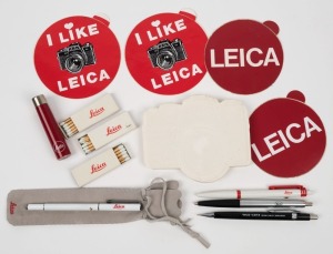 LEITZ: One Leica promotional cigarette lighter with three Leica-branded boxes of matches, together with four Leica-branded writing implements, one of them presented in its original Leica felt pouch, among other stationery items. (13 items)