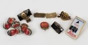 LEITZ: Various Leica-branded metal badges and lapel pins, including eight Leica 'Red Dot' logo pins, and one Leica 'Olympia 92' badge, among others.&nbsp;(14 items)