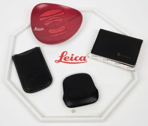 LEITZ: Five Leica-branded promotional items, including two trays, two leather wallets, and one black leather purse. (5 items)