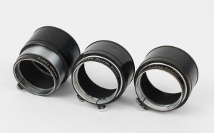 LEITZ: Three Leica FIKUS variable lens hoods, each with a different variation in engraving detail. (3 items)