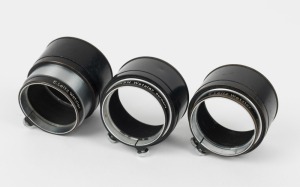 LEITZ: Three Leica FIKUS variable lens hoods, each with a different variation in engraving detail. (3 items)