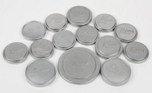 LEITZ: Fourteen metal Leica front lens caps. (14 items)