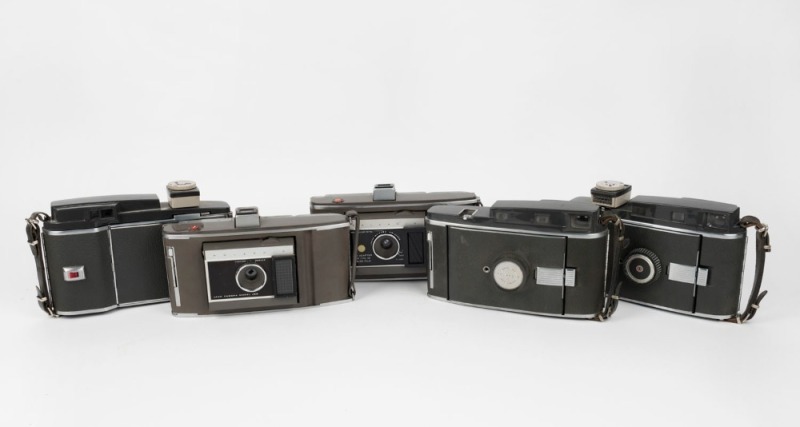 POLAROID: A selection of five instant rollfilm cameras, circa late 1950s, comprising two Polaroid 110A Pathfinder models with viewfinder attachment, two Polaroid J66 models, and one Polaroid 160 model. (5 cameras)