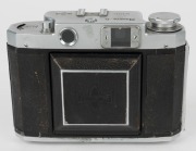 MAMIYA: Mamiya-6 IV horizontal-folding camera [#39191], circa 1951, with Zuiko 75mm f3.5 lens [#39089] and Seikosha-Rapid shutter. 'Made in Occupied Japan' embossed into the leather on the side.  - 3