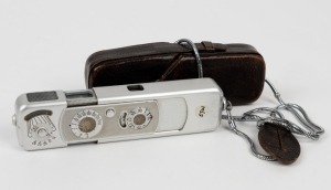 MINOX: Chrome-body Minox B subminiature camera [#621 479], circa 1962, with Complan 15mm f3.5 lens, together with leather case and wrist chain. Scale in meters.