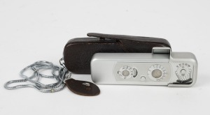 MINOX: Chrome-body Minox B subminiature camera [#824 825], circa 1964, with Complan 15mm f3.5 lens, leather case with chain, and right-angle mirror finder attachment intended for inconspicuous photography.