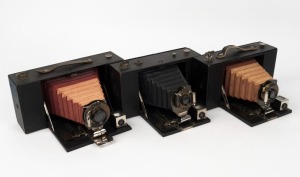 KODAK: Three circa 1910 folding cameras - one Folding Brownie No. 3 with maroon bellows [#48553-F], one Folding Brownie No. 3A also with maroon bellows [#17503], and one Folding Brownie No. 3D with black bellows [#79604F]. (3 cameras)