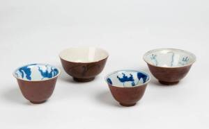 Four Chinese blue and white and russet glazed tea bowls, late Qing Dynasty, largest 9.5cm diameter