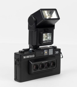 NIMSLO: Nimslo 3D 35mm film camera with viewfinder with 30mm quadra lenses, circa 1980s [#320670838], together with a Nimslo Opti-Lite shoe-mounted flash unit. Made in Japan.