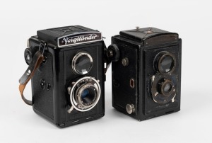 VOIGTLÄNDER: Two Brillant TLR cameras - one 1932 model [#121857] with Voigtar 75mm f7.7 lens, the other a 1937 V6 model with Voigtar 75mm f6.3 lens [#3112888] and original leather strap. (2 cameras)