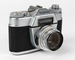 VOIGTLÄNDER: 1959 Bessamatic SLR camera [#59129] with Color-Skopar 50mm f2.8 lens [#5019762], Synchro-Compur shutter, accessory shoe, and Accura UV filter.