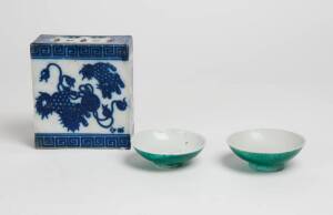 A Japanese blue and white pillow, 14cm wide, circa 1900 and two small cups
