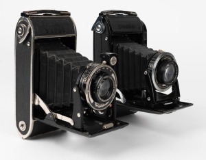 VOIGTLÄNDER: Two vertical-folding cameras - one 1947 Bessa RF with Skopar 105mm f3.5 lens [#2388759] and Compur-Rapid shutter, and one 1937 black-enamel Bessa [#G434722] with Voigtar 110mm f4.5 lens and shutter release cable. (2 cameras)
