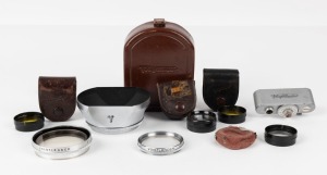 VOIGTLÄNDER: Various camera accessories of various sizes, including six lens filters, three of them in original Voigtländer-branded leather pouches, one 93/184 rangefinder shoe accessory, and one 310/49 lens hood in original fitted leather pouch. (8 items