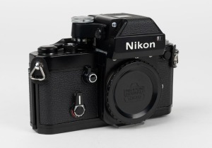 NIPPON KOGAKU: Nikon F2 Photomic camera body [#F2 7586175], circa 1976, in black, with plastic Nikon F lens cap.