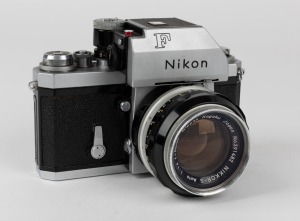 NIPPON KOGAKU: Nikon F Photomic Tn SLR camera [#6571955], circa 1968, with Nikkor-S Auto 50mm f1.4 lens [#391482], L1A Nikon filter, and plastic lens cap.