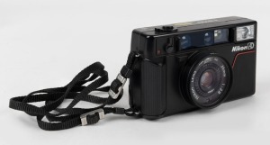 NIPPON KOGAKU: Nikon L35 AD point-and-shoot camera [#1379442], circa 1983, with 35mm f2.8 lens, Nikon L37 46mm lens filter, and wrist strap.