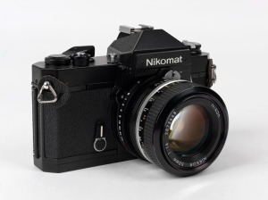 NIPPON KOGAKU: Black-body Nikon Nikomat FT2 SLR camera [#FT2 5103458], circa 1976, with Nikkor 50mm f1.4 lens [#3873448].