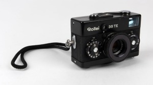 FRANKE & HEIDECKE: Black-body Rollei 35TE compact camera, circa 1980, with Tessar 40mm f3.5 lens, rubber lens hood, and wrist strap.