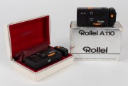 FRANKE & HEIDECKE: Two satin-black&nbsp;Rollei&nbsp;A110 subminiature cameras [#3242194 & #3222027] with Tessar&nbsp;23mm f2.8 lenses, circa 1978, with one in maker's box with flash unit, neck chain, and instruction booklet. (2 cameras)