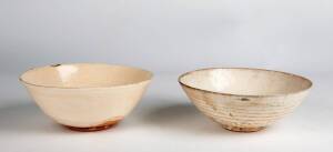 Two Chinese Cizhou-type bowls, Ming Dynasty, each with spur mark in the centre and a thick creamy glaze, both 19.5cm diameter