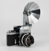 NIPPON KOGAKU: Nikon F&nbsp;Photomic&nbsp;T SLR&nbsp;camera [#6766494], circa 1965, with Nikkor-S Auto 35mm f2.8 wide-angle lens [#371067], Photomic T metering prism, and Nikon F BC-7 flash unit attachment.