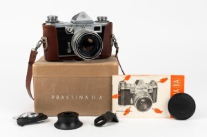 KAMERA-WERKSTÄTTEN: Circa 1958 Praktina IIa SLR camera [#107 565] with Flexon 50mm f2 lens {#5471997] and front lens cap. Together with maker's box, leather body casing, lens hood, rapid-wind lever accessory, and instruction booklet.