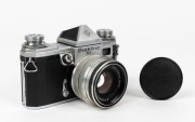 KAMERA-WERKST&Auml;TTEN: Circa 1958 Praktina IIa SLR camera [#107 565] with Flexon 50mm f2 lens {#5471997] and front lens cap. Together with maker's box, leather body casing, lens hood, rapid-wind lever accessory, and instruction booklet. - 2