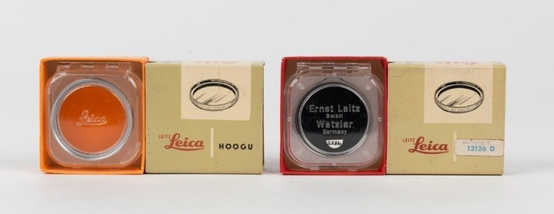 LEITZ: Two Leica E39 lens filters - one HOOGU/13101 orange and one HOOET/13126 dark red, both with original maker's boxes and plastic cases. (2 items)