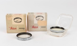 LEITZ: Two Leica E41 lens filters - one XOOPT/13155 v. light yellow and one XOOYL/13205 UVa, both with original maker's boxes and plastic cases. (2 items)