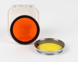 LEITZ: Two circa 1939 Leica lens filters - one GCOOL medium yellow and one GDOOK orange in original plastic case. (2 items)