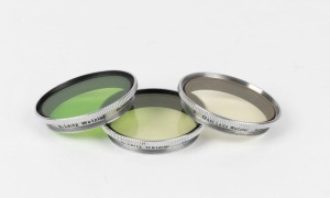 LEITZ: Three circa 1939 Leica lens filters - one GBOOM v. light yellow, one GHIOO UVa, and one GCYOD green. (3 items)