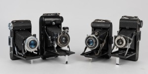 VARIOUS MANUFACTURERS: A selection of early 20th-century vertical-folding cameras, including models from Kershaw, Belfoca, and Kinax. (4 cameras)