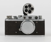 FED: Fed-1g Leica-copy rangefinder camera [#711147], circa 1955, with Fed 50mm f3.5 lens, metal lens cap, and finder attachment. - 2