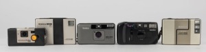 KONICA: Five automatic compact cameras - one gold-body Big Mini BM-201, one Kanpai, one Pocket 400, one Disc 15, and one AA-35. (5 cameras)