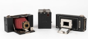 KODAK: A selection of four Kodak camera products, circa 1910, comprising one transparency enlarger, one Vest Pocket Kodak Enlarging Camera in maker's box, one Brownie, and one Pocket Brownie. (4 items)