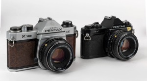 ASAHI KOGAKU: Two SLR cameras - one 1982 brown leatherette Special Edition K1000 [#6451161], and one 1979 Pentax MV [#3157335], both with SMC Pentax-M 50mm f2 lenses [#3833746 & #5164242]. (2 cameras)