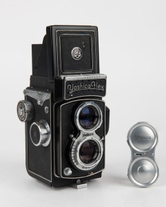 YASHICA: Yashicaflex S TLR camera [#67 232], circa 1954, with Heliotar 80mm f3.5 lens [#237797] and Copal shutter, together with metal lens cap. The first Japanese camera with built-in selenium meter.